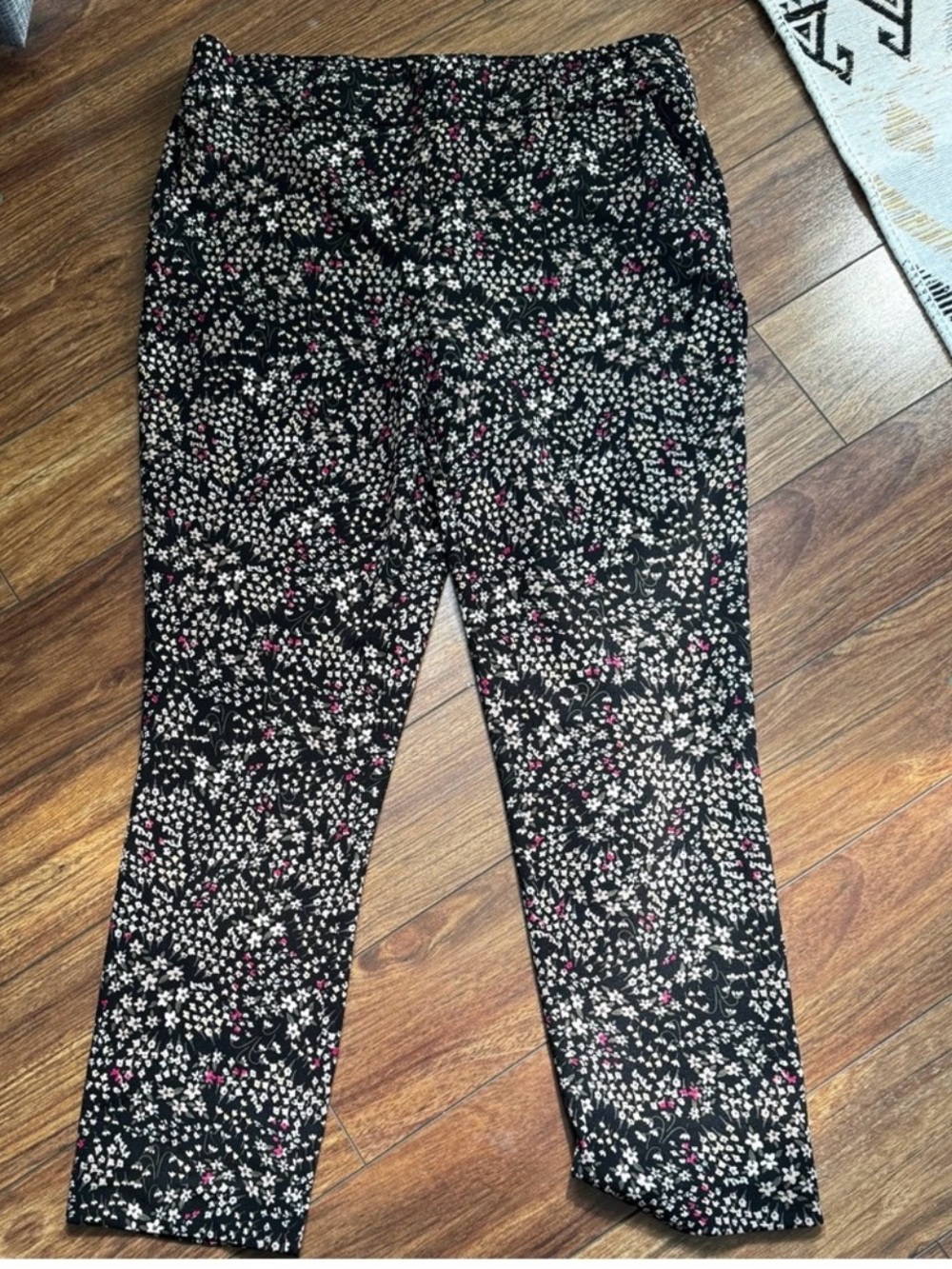 Jules & Leopold black pants featuring a small white and pink floral pattern